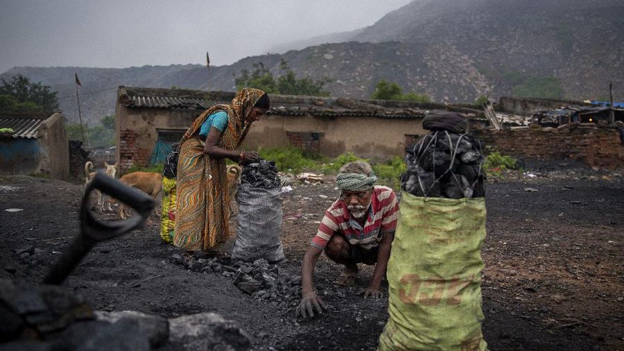 A man climbs a steep ridge with a basket of coal scavenged from a mine near Dhanbad, an eastern Indian city in Jharkhand state, Friday, Sept. 24, 2021. A 2021 Indian government study found that Jharkhand state -- among the poorest in India and the state with the nation’s largest coal reserves -- is also the most vulnerable Indian state to climate change. Efforts to fight climate change are being held back in part because coal, the biggest single source of climate-changing gases, provides cheap electricity and supports millions of jobs. It's one of the dilemmas facing world leaders gathered in Glasgow, Scotland this week in an attempt to stave off the worst effects of climate change. (AP Photo/Altaf Qadri)