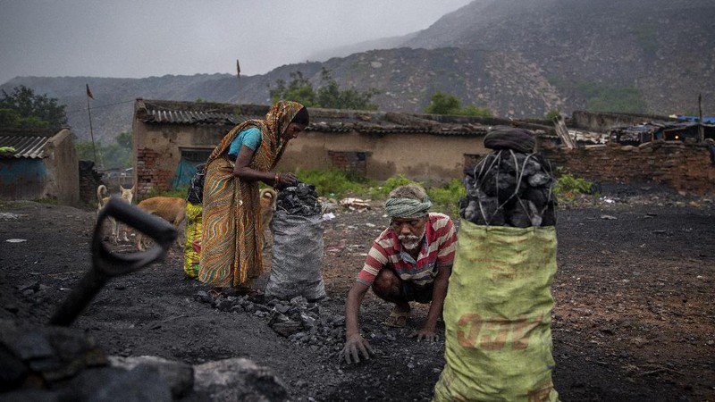 A man climbs a steep ridge with a basket of coal scavenged from a mine near Dhanbad, an eastern Indian city in Jharkhand state, Friday, Sept. 24, 2021. A 2021 Indian government study found that Jharkhand state -- among the poorest in India and the state with the nation’s largest coal reserves -- is also the most vulnerable Indian state to climate change. Efforts to fight climate change are being held back in part because coal, the biggest single source of climate-changing gases, provides cheap electricity and supports millions of jobs. It's one of the dilemmas facing world leaders gathered in Glasgow, Scotland this week in an attempt to stave off the worst effects of climate change. (AP Photo/Altaf Qadri)