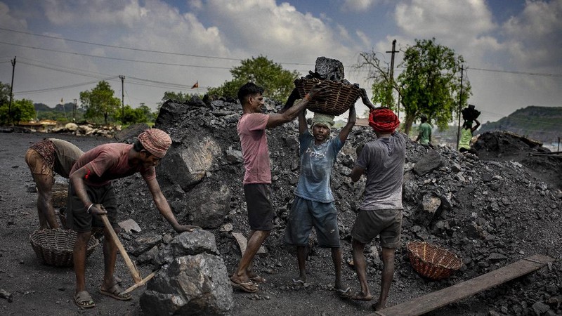 A man climbs a steep ridge with a basket of coal scavenged from a mine near Dhanbad, an eastern Indian city in Jharkhand state, Friday, Sept. 24, 2021. A 2021 Indian government study found that Jharkhand state -- among the poorest in India and the state with the nation’s largest coal reserves -- is also the most vulnerable Indian state to climate change. Efforts to fight climate change are being held back in part because coal, the biggest single source of climate-changing gases, provides cheap electricity and supports millions of jobs. It's one of the dilemmas facing world leaders gathered in Glasgow, Scotland this week in an attempt to stave off the worst effects of climate change. (AP Photo/Altaf Qadri)