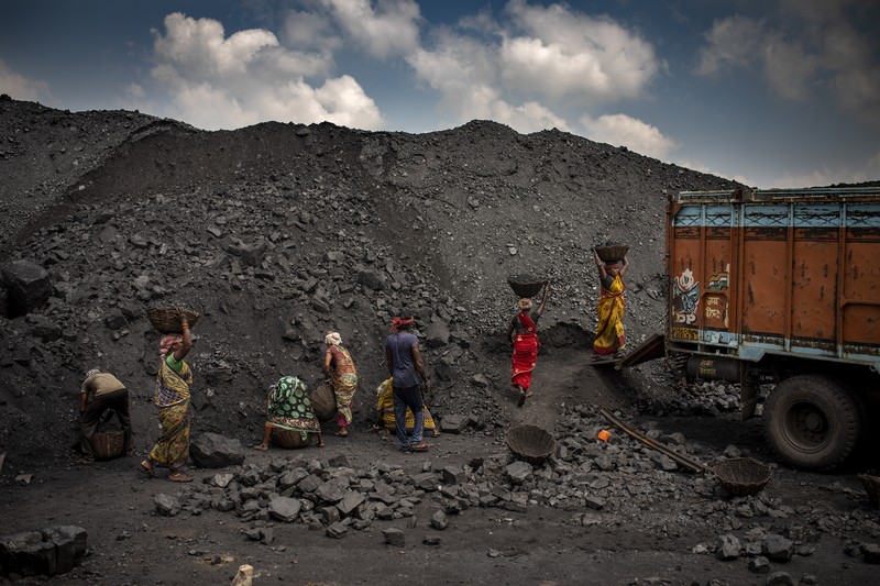 A man climbs a steep ridge with a basket of coal scavenged from a mine near Dhanbad, an eastern Indian city in Jharkhand state, Friday, Sept. 24, 2021. A 2021 Indian government study found that Jharkhand state -- among the poorest in India and the state with the nation’s largest coal reserves -- is also the most vulnerable Indian state to climate change. Efforts to fight climate change are being held back in part because coal, the biggest single source of climate-changing gases, provides cheap electricity and supports millions of jobs. It's one of the dilemmas facing world leaders gathered in Glasgow, Scotland this week in an attempt to stave off the worst effects of climate change. (AP Photo/Altaf Qadri)