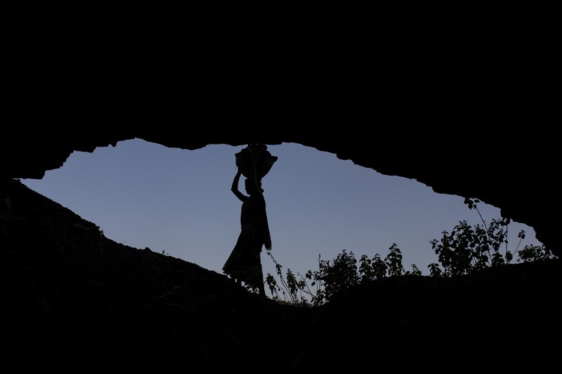 A man climbs a steep ridge with a basket of coal scavenged from a mine near Dhanbad, an eastern Indian city in Jharkhand state, Friday, Sept. 24, 2021. A 2021 Indian government study found that Jharkhand state -- among the poorest in India and the state with the nation’s largest coal reserves -- is also the most vulnerable Indian state to climate change. Efforts to fight climate change are being held back in part because coal, the biggest single source of climate-changing gases, provides cheap electricity and supports millions of jobs. It's one of the dilemmas facing world leaders gathered in Glasgow, Scotland this week in an attempt to stave off the worst effects of climate change. (AP Photo/Altaf Qadri)