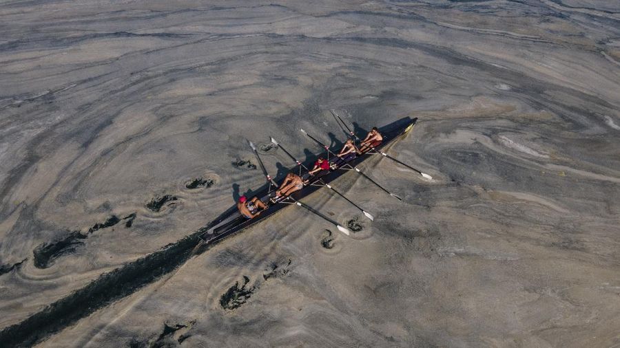 A kayaker fishes in Lake Oroville as water levels remain low due to continuing drought conditions in Oroville, Calif., Aug. 22, 2021. (AP Photo/Ethan Swope)