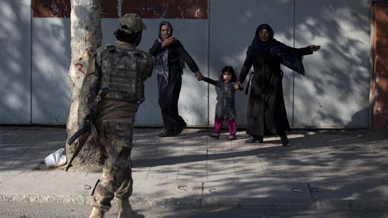 Taliban fighters block roads after an explosion Tuesday, Nov. 2, 2021. An explosion went off Tuesday at the entrance of a military hospital in Kabul, killing severa; people and wounding over a dozen, health officials said.(AP Photo/Ahmad Halabisaz)