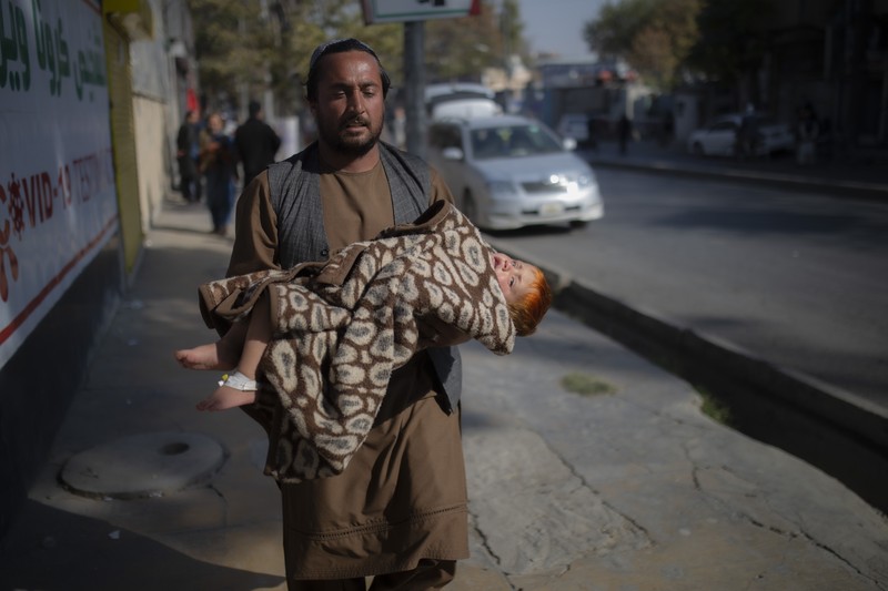 Taliban fighters block roads after an explosion Tuesday, Nov. 2, 2021. An explosion went off Tuesday at the entrance of a military hospital in Kabul, killing severa; people and wounding over a dozen, health officials said.(AP Photo/Ahmad Halabisaz)