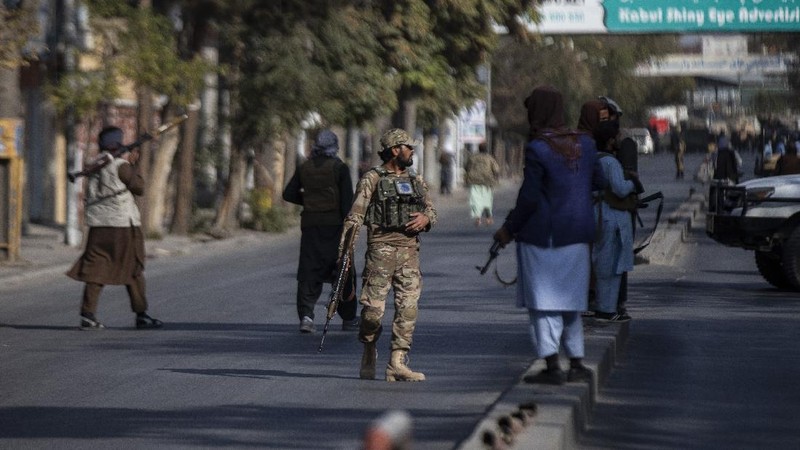 Taliban fighters block roads after an explosion Tuesday, Nov. 2, 2021. An explosion went off Tuesday at the entrance of a military hospital in Kabul, killing severa; people and wounding over a dozen, health officials said.(AP Photo/Ahmad Halabisaz)