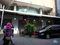 Warga melihat selembaran kertas yang tertempel digerai Matahari Store, Pasar Baru, Jakarta, Selasa (2/11/2021). Matahari Departemen Store menutup gerainya yang ada di Pasar Baru, didrpan lokasi hanya terpakir kendaraan pengunjung gerai lain. Menurut