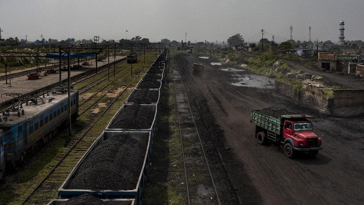 A truck loaded with coal drives past a stationary freight train carrying coal at Chainpur village near Hazaribagh, in eastern state of Jharkhand, Sunday, Sept. 26, 2021. A 2021 Indian government study found that Jharkhand state -- among the poorest in India and the state with the nation’s largest coal reserves -- is also the most vulnerable Indian state to climate change. Efforts to fight climate change are being held back in part because coal, the biggest single source of climate-changing gases, provides cheap electricity and supports millions of jobs. It's one of the dilemmas facing world leaders gathered in Glasgow, Scotland this week in an attempt to stave off the worst effects of climate change. (AP Photo/Altaf Qadri)