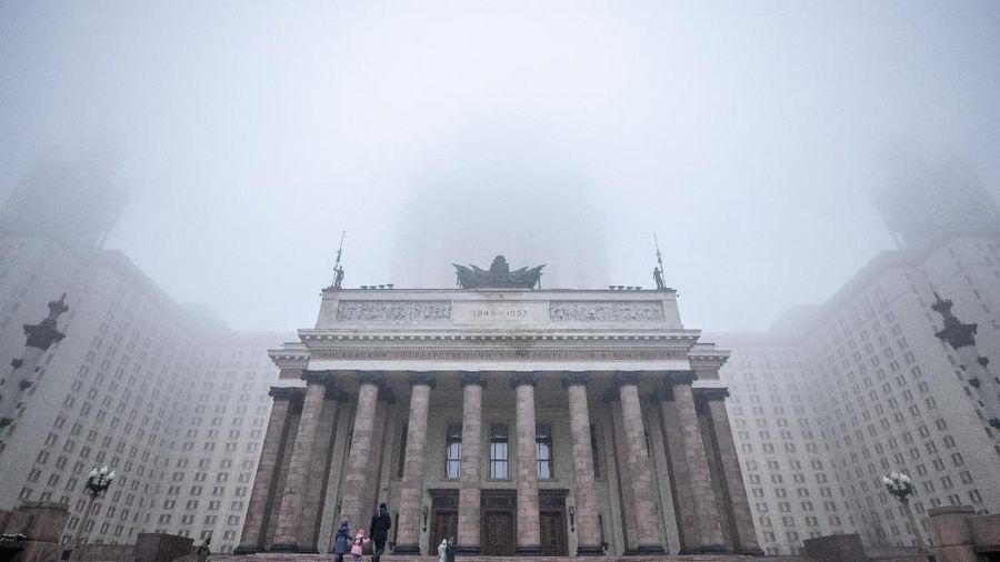 People walk by the entrance of Moscow State University building during heavy fog in Moscow, Russia November 2, 2021. REUTERS/Maxim Shemetov
