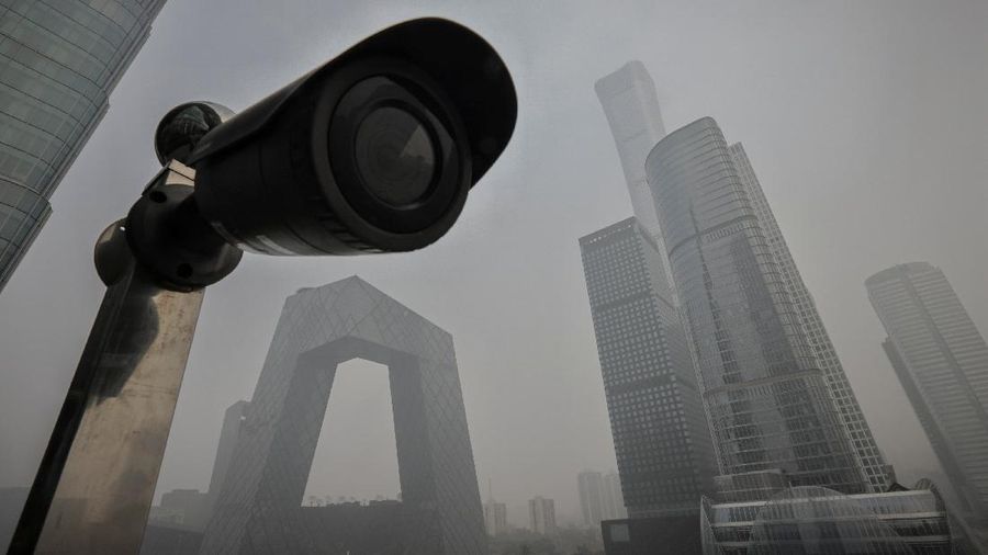 A surveillance camera points at a terrace of a shopping mall overlooking the skyline of the Central Business District on a polluted day in Beijing, China, November 5, 2021.  REUTERS/Thomas Peter