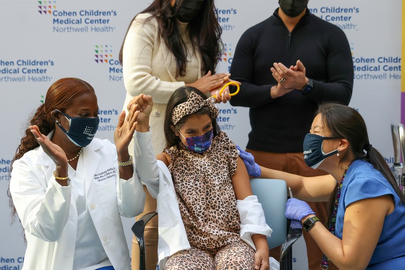 Nora Gossett, 7, reacts as she receives the Pfizer-BioNTech COVID-19 vaccine from Sophia Jan, MD, while her father Jeff Gossett, MD, holds her hand at Cohen Children's Medical Center as vaccines were approved for children aged 5-11, amid the coronavirus disease pandemic, in New Hyde Park, New York, U.S., November 4, 2021. REUTERS/Andrew Kelly