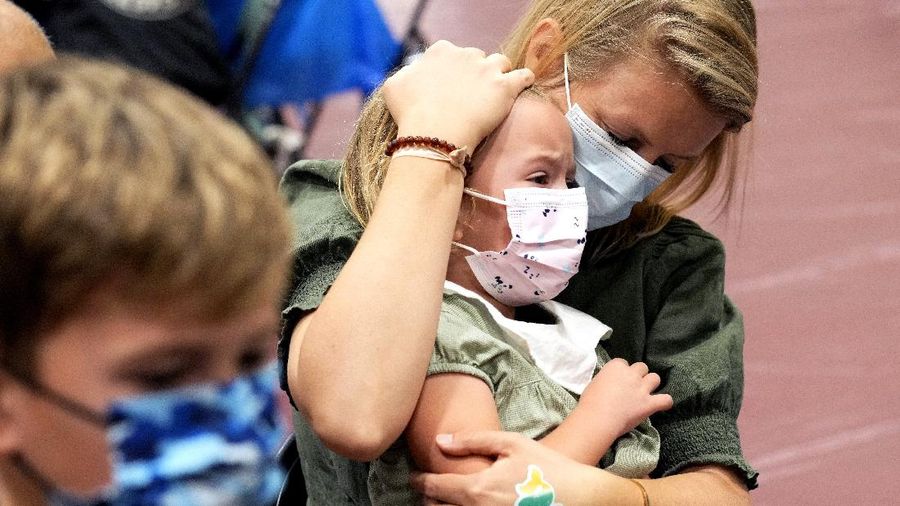 Joanna Nagata, of Pasadena, comforts her 5 year-old daughter Mallory Nagata as she waits to receive her COVID-19 vaccine during an event kicking off coronavirus vaccinations for children age 5-11 at Eugene A. Obregon Park in Los Angeles on Wednesday, Nov. 3, 2021. (Keith Birmingham/The Orange County Register via AP)