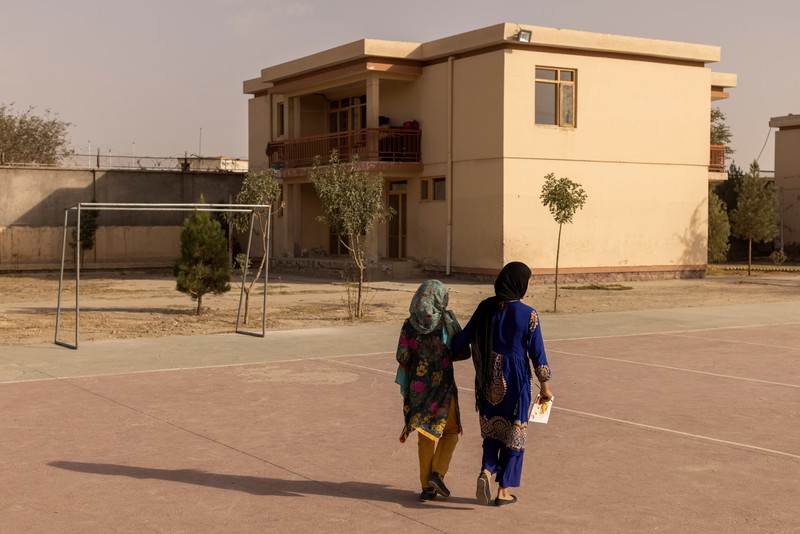 Golshan, a childcare worker at the orphanage, serves the children tea and bread for breakfast in Kabul, Afghanistan, October 12, 2021. Orphanages like this play an outsize role in Afghanistan, where tens of thousands of civilians have been killed in wars that have ravaged the country for more than 40 years. The lack of funding, which has hit charities, non-governmental organisations and ordinary Afghans since the hardline Islamist Taliban movement took back control of the country, is forcing orphanage director Ahmad Khalil Mayan (not pictured) into tough choices. 