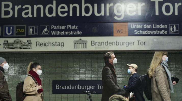 Commuters wearing face masks to protect against the coronavirus as they walk through the public transport station Brandenburger Tor in central Berlin, Germany, Friday, Nov. 12, 2021. Germany battles a fourth wave of the coronavirus with high number of infections in the recent days. (AP Photo/Markus Schreiber)