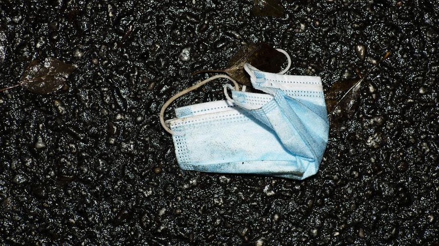 A used face mask is left on a street in Berlin, Germany, Friday, Nov. 12, 2021. Germany battles a fourth wave of the coronavirus with high number of infections in the recent days. (AP Photo/Markus Schreiber)