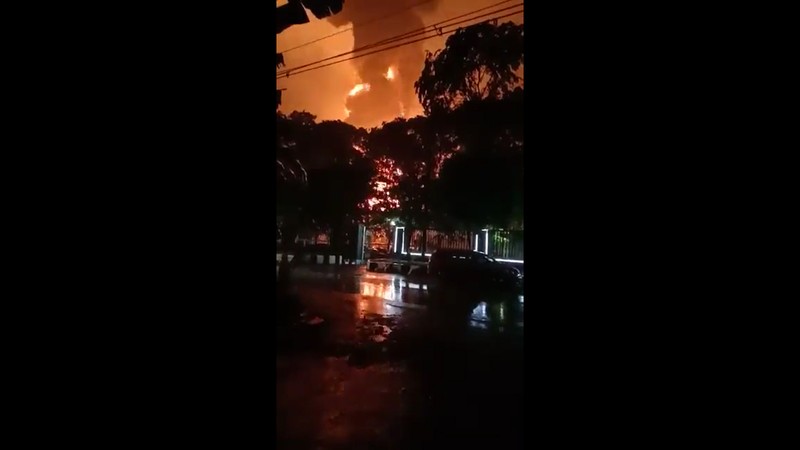 Indonesia Refinery Fire The sky glows from the fire that razes through an oil refinery owned by the national oil company Pertamina, in Cilacap, Central Java, Indonesia, Saturday, Nov. 13, 2021. The fire at a gasoline storage at the largest oil refinery on Indonesia's Java island prompted the evacuation of dozens of residents living nearby. (AP Photo/Agus Fitrah)