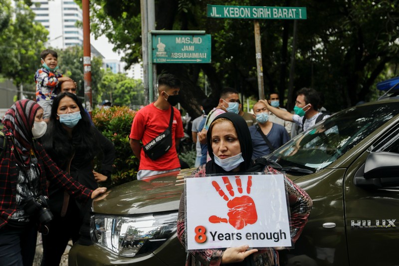Indonesia Afghan Refugees Afghan women and children refugees living in Indonesia hold posters during a rally outside a building that houses UNHCR representative office in Jakarta, Indonesia, Monday, Nov. 15, 2021. Hundreds of Afghan refugees and asylum seekers living in Indonesia rallied in front of the U.N. refugee agency office in Jakarta on Monday to urge it to speed up their resettlement.(AP Photo/Achmad Ibrahim)