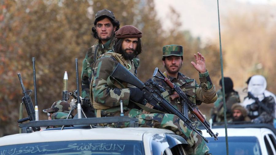 Members of Taliban sit on a military vehicle during Taliban military parade in Kabul, Afghanistan November 14, 2021. REUTERS/Ali Khara NO RESALES. NO ARCHIVES TPX IMAGES OF THE DAY