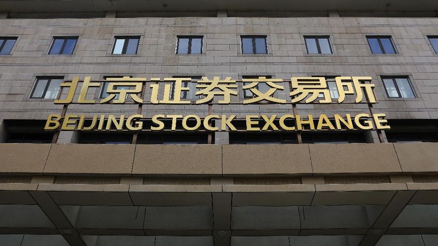 Men are seen near the new Beijing Stock Exchange building at the Financial Street, in Beijing, China, November 15, 2021. REUTERS/Tingshu Wang