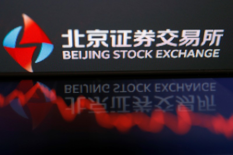 Men are seen near the new Beijing Stock Exchange building at the Financial Street, in Beijing, China, November 15, 2021. REUTERS/Tingshu Wang