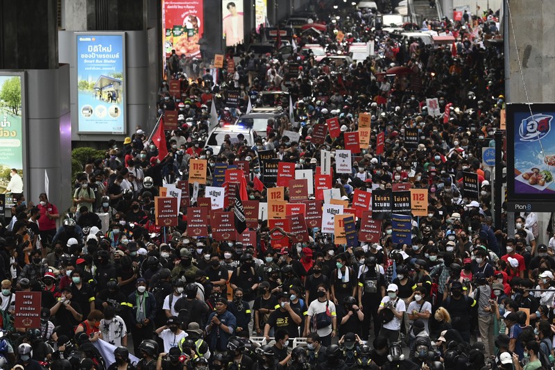 CORRECTS YEAR - Anti-government protesters hold banners calling for the monarchy reform marching to the German embassy in Bangkok, Thailand, Sunday, Nov. 14, 2021. Protesters calling for the reform of the monarchy returned to the streets of Bangkok despite the ruling of the Constitutional Court on Wednesday that such demands are tantamount to attempting to overthrow the system of government with the king as head of state. (AP Photo/Surat Sappakun)