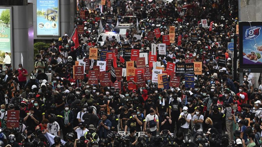 CORRECTS YEAR - Anti-government protesters hold banners calling for the monarchy reform marching to the German embassy in Bangkok, Thailand, Sunday, Nov. 14, 2021. Protesters calling for the reform of the monarchy returned to the streets of Bangkok despite the ruling of the Constitutional Court on Wednesday that such demands are tantamount to attempting to overthrow the system of government with the king as head of state. (AP Photo/Surat Sappakun)