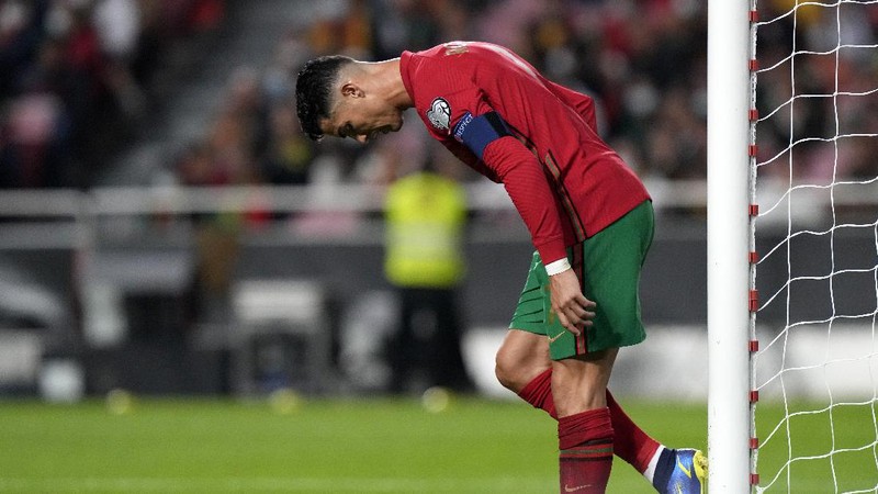 Serbia's Nikola Milenkovic, top, duels for the ball with Portugal's Cristiano Ronaldo, center left, and Portugal's Danilo Pereira, right, during the World Cup 2022 group A qualifying soccer match between Portugal and Serbia at the Luz stadium in Lisbon, Sunday, Nov 14, 2021. (AP Photo/Armando Franca)