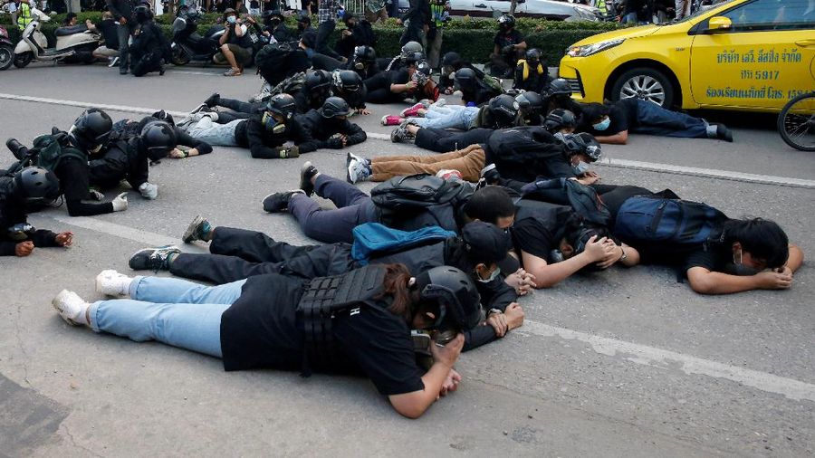 CORRECTS YEAR - Anti-government protesters hold banners calling for the monarchy reform marching to the German embassy in Bangkok, Thailand, Sunday, Nov. 14, 2021. Protesters calling for the reform of the monarchy returned to the streets of Bangkok despite the ruling of the Constitutional Court on Wednesday that such demands are tantamount to attempting to overthrow the system of government with the king as head of state. (AP Photo/Surat Sappakun)