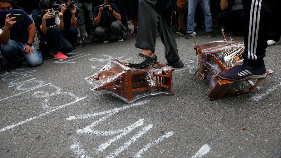 CORRECTS YEAR - Anti-government protesters hold banners calling for the monarchy reform marching to the German embassy in Bangkok, Thailand, Sunday, Nov. 14, 2021. Protesters calling for the reform of the monarchy returned to the streets of Bangkok despite the ruling of the Constitutional Court on Wednesday that such demands are tantamount to attempting to overthrow the system of government with the king as head of state. (AP Photo/Surat Sappakun)