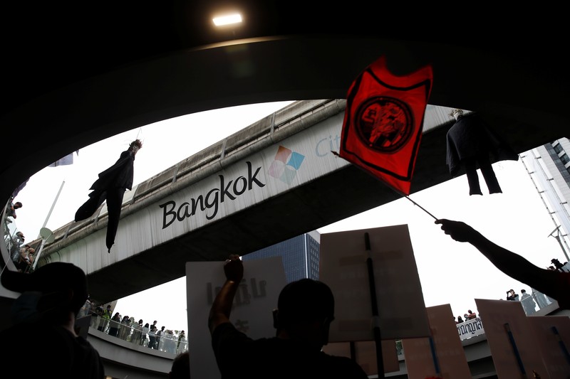 CORRECTS YEAR - Anti-government protesters hold banners calling for the monarchy reform marching to the German embassy in Bangkok, Thailand, Sunday, Nov. 14, 2021. Protesters calling for the reform of the monarchy returned to the streets of Bangkok despite the ruling of the Constitutional Court on Wednesday that such demands are tantamount to attempting to overthrow the system of government with the king as head of state. (AP Photo/Surat Sappakun)