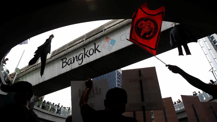 CORRECTS YEAR - Anti-government protesters hold banners calling for the monarchy reform marching to the German embassy in Bangkok, Thailand, Sunday, Nov. 14, 2021. Protesters calling for the reform of the monarchy returned to the streets of Bangkok despite the ruling of the Constitutional Court on Wednesday that such demands are tantamount to attempting to overthrow the system of government with the king as head of state. (AP Photo/Surat Sappakun)