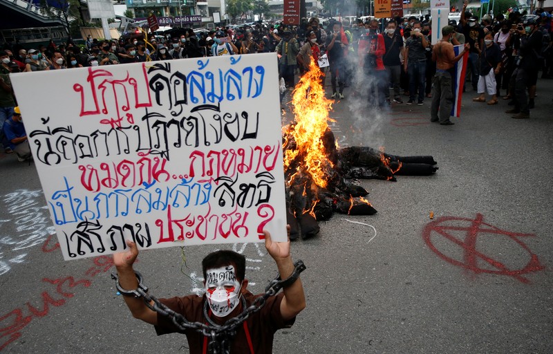 CORRECTS YEAR - Anti-government protesters hold banners calling for the monarchy reform marching to the German embassy in Bangkok, Thailand, Sunday, Nov. 14, 2021. Protesters calling for the reform of the monarchy returned to the streets of Bangkok despite the ruling of the Constitutional Court on Wednesday that such demands are tantamount to attempting to overthrow the system of government with the king as head of state. (AP Photo/Surat Sappakun)