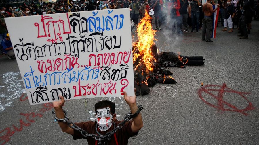 CORRECTS YEAR - Anti-government protesters hold banners calling for the monarchy reform marching to the German embassy in Bangkok, Thailand, Sunday, Nov. 14, 2021. Protesters calling for the reform of the monarchy returned to the streets of Bangkok despite the ruling of the Constitutional Court on Wednesday that such demands are tantamount to attempting to overthrow the system of government with the king as head of state. (AP Photo/Surat Sappakun)