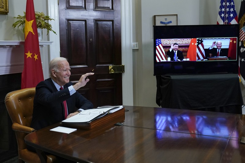 Biden US China President Joe Biden waves as he meets virtually with Chinese President Xi Jinping from the Roosevelt Room of the White House in Washington, Monday, Nov. 15, 2021. (AP Photo/Susan Walsh)
