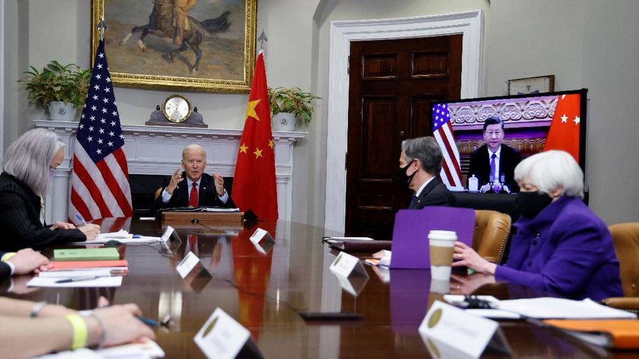 President Joe Biden waves as he meets virtually with Chinese President Xi Jinping from the Roosevelt Room of the White House in Washington, Monday, Nov. 15, 2021. (AP Photo/Susan Walsh)