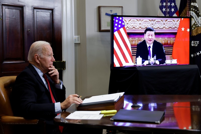 President Joe Biden waves as he meets virtually with Chinese President Xi Jinping from the Roosevelt Room of the White House in Washington, Monday, Nov. 15, 2021. (AP Photo/Susan Walsh)