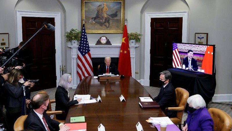 President Joe Biden waves as he meets virtually with Chinese President Xi Jinping from the Roosevelt Room of the White House in Washington, Monday, Nov. 15, 2021. (AP Photo/Susan Walsh)