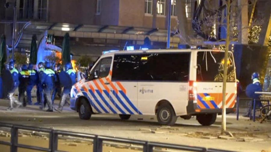 In this image taken from video, police arrive as demonstrators protest against government restrictions due to the coronavirus pandemic, Friday, Nov. 19, 2021, in Rotterdam, Netherlands. Police fired warning shots, injuring an unknown number of people, as riots broke out Friday night in downtown Rotterdam at a demonstration against plans by the government to restrict access for unvaccinated people to some venues. (Media TV Rotterdam via AP)