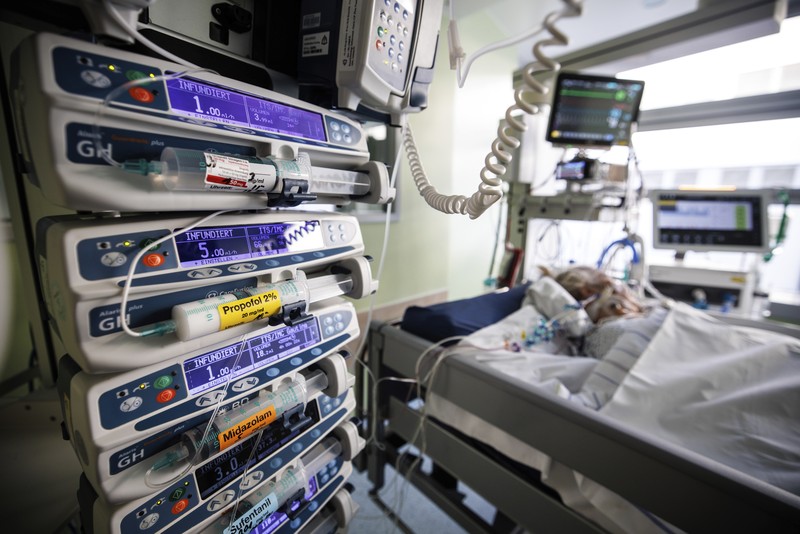 Lorenz Nowak, head physician of the Clinic for Intensive Care Medicine, treats a COVID-19 patient in the ICU of the Asklepios Clinic, in Gauting, Germany, Friday, Nov. 19, 2021. The head of Germany’s disease control agency said Friday that the country has entered into a “nationwide state of emergency” because of surging coronavirus infections. The head of the Robert Koch Institute said regular medical care cannot be guaranteed anymore in some parts of the country because hospitals and intensive care wards are overstretched. (Matthias Balk/dpa via AP)