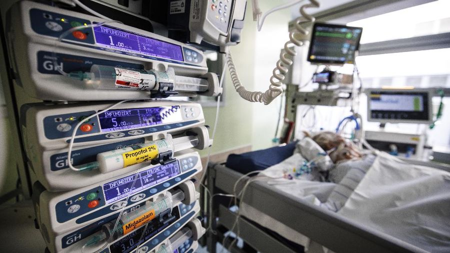 Lorenz Nowak, head physician of the Clinic for Intensive Care Medicine, treats a COVID-19 patient in the ICU of the Asklepios Clinic, in Gauting, Germany, Friday, Nov. 19, 2021. The head of Germany’s disease control agency said Friday that the country has entered into a “nationwide state of emergency” because of surging coronavirus infections. The head of the Robert Koch Institute said regular medical care cannot be guaranteed anymore in some parts of the country because hospitals and intensive care wards are overstretched. (Matthias Balk/dpa via AP)
