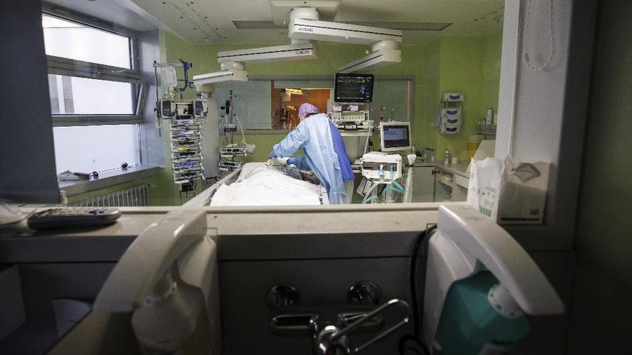 Lorenz Nowak, head physician of the Clinic for Intensive Care Medicine, treats a COVID-19 patient in the ICU of the Asklepios Clinic, in Gauting, Germany, Friday, Nov. 19, 2021. The head of Germany’s disease control agency said Friday that the country has entered into a “nationwide state of emergency” because of surging coronavirus infections. The head of the Robert Koch Institute said regular medical care cannot be guaranteed anymore in some parts of the country because hospitals and intensive care wards are overstretched. (Matthias Balk/dpa via AP)