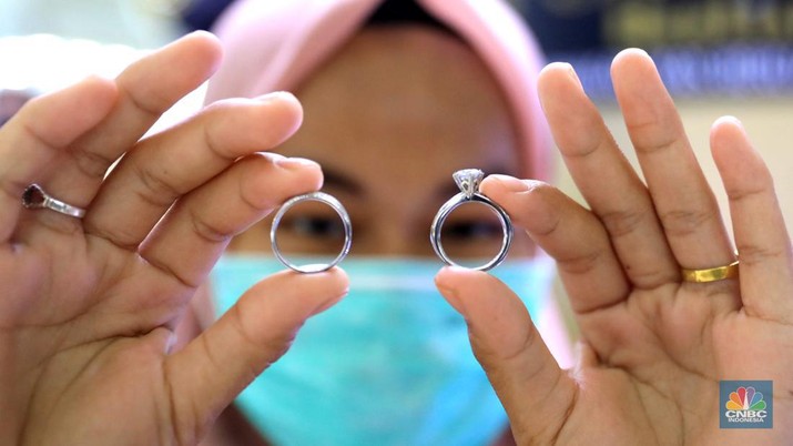 Ilustrasi Perhiasan Perak Petugas menunjukkan cincin perak di pasar mas Cikini, Senin, 22/11. Harga perak dunia turun pada perdagangan ini di tengah kebimbangan antara potensi inflasi yang lebih tinggi dan sikap The Fed yang menahan suku bunga. Harga perak di pasar spot tercatat US$ 15,0200/troy ons, turun 0,12% . Pantauan CNBC Indonesia di lokasi. Harga perak terpantau stabil Di toko Bukit Mas, harga perak dijual per-ring seharga Rp700 ribu. Di Toko Yossi berlian perak dijual per gram seharga Rp200 ribu. (CNBC Indonesia/ Muhammad Sabki)