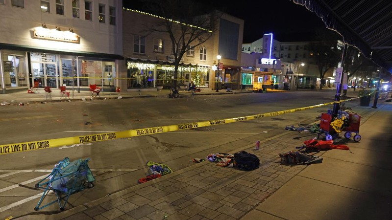 A red SUV speeds past attendees moments before plowing into a crowd at a Christmas parade in Waukesha, Wisconsin, U.S., in this still image taken from a November 21, 2021 social media video. CITY OF WAUKESHA/Facebook/via REUTERS THIS IMAGE HAS BEEN SUPPLIED BY A THIRD PARTY. MANDATORY CREDIT. NO RESALES. NO ARCHIVES.
