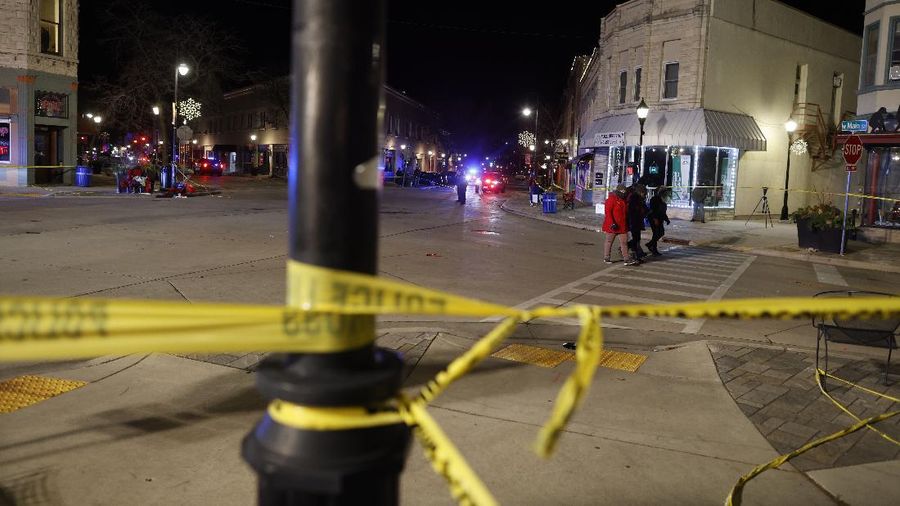 A red SUV speeds past attendees moments before plowing into a crowd at a Christmas parade in Waukesha, Wisconsin, U.S., in this still image taken from a November 21, 2021 social media video. CITY OF WAUKESHA/Facebook/via REUTERS THIS IMAGE HAS BEEN SUPPLIED BY A THIRD PARTY. MANDATORY CREDIT. NO RESALES. NO ARCHIVES.