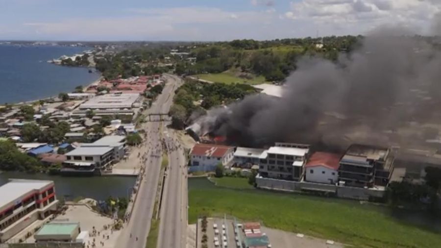 Asap mengepul dari gedung-gedung yang terbakar selama protes di ibu kota Honiara, Kepulauan Solomon, Kamis (25/11/2021).  (Australian Broadcasting Corporation via AP)