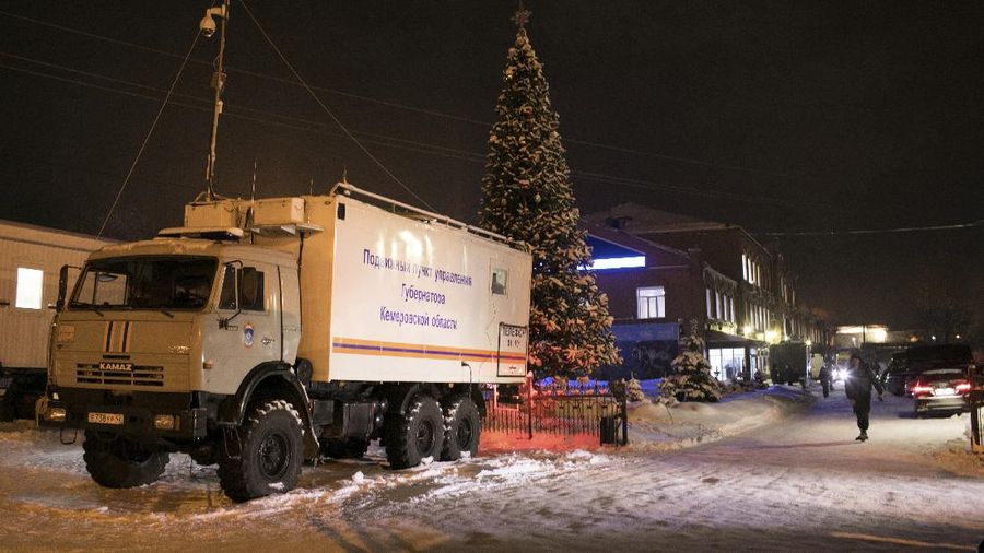 The crew of a Dutch ambulance brings a COVID-19 19 patient from Rotterdam to BG University Hospital Bochum, Germany, Tuesday, Nov. 23, 2021. The country is this week expected to pass 100,000 coronavirus-related deaths since the start of the pandemic. Hospitals warn that ICU capacities are nearly exhausted, with some patients having to be transferred to clinics in other parts of Germany. (Roland Weihrauch/dpa via AP)