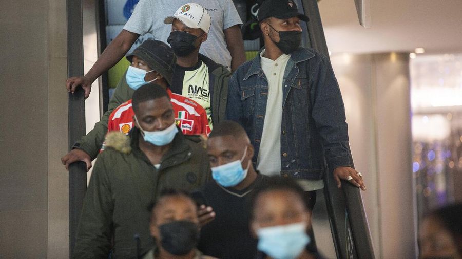 People wearing masks on an escalator at a shopping mall, in Johannesburg, South Africa, Friday Nov. 26, 2021. Advisers to the World Health Organization are holding a special session Friday to flesh out information about a worrying new variant of the coronavirus that has emerged in South Africa, though its impact on COVID-19 vaccines may not be known for weeks. (AP Photo/Denis Farrell)