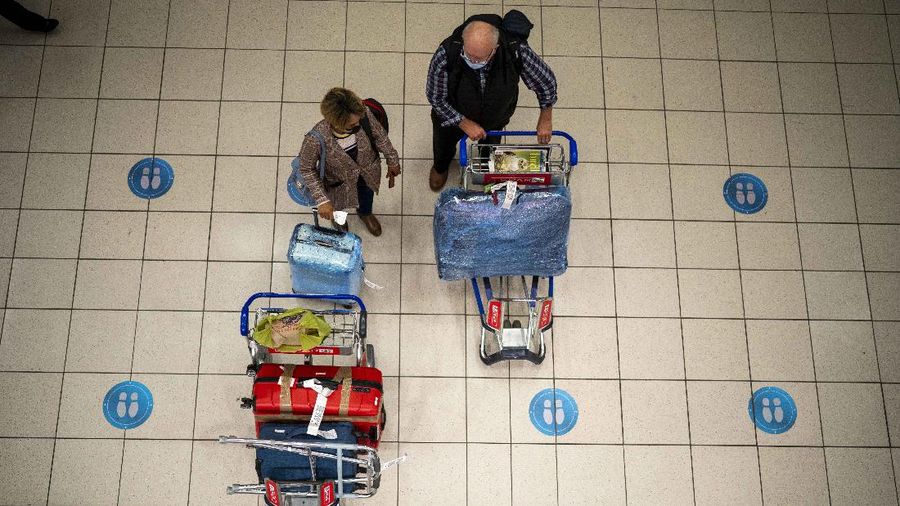 People wait at OR Tambo's airport in Johannesburg, South Africa', Friday Nov. 26, 2021. A slew of nations moved to stop air travel from southern Africa on Friday in reaction to news of a new, potentially more transmissible COVID-19 variant that has been detected in South Africa. Scientists say it is a concern because of its high number of mutations and rapid spread among young people in Gauteng, the country's most populous province. (AP Photo/Jerome Delay)