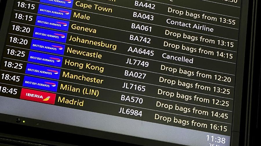 A departures screen displays a cancelled flight to Johannesburg and a message to contact the airline for a scheduled flight to Capetown, at London's Heathrow Airport, Friday, Nov. 26, 2021. The U.K. announced that it was banning flights from South Africa and five other southern African countries effective at noon on Friday, and that anyone who had recently arrived from those countries would be asked to take a coronavirus test. (AP Photo/Alberto Pezzali)