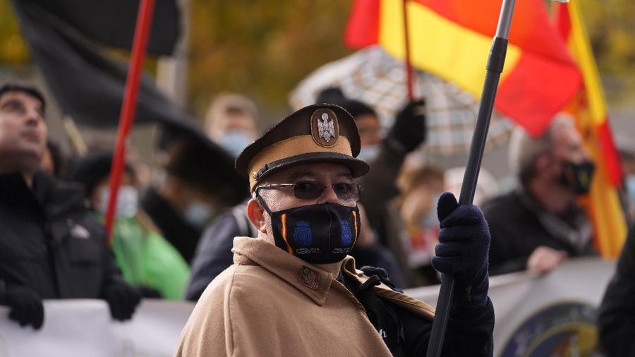 A protester dressed in an old style uniform marches during a police protest in Madrid, Spain, Saturday, Nov. 27, 2021. Tens of thousands of Spanish police officers and their supporters rallied in Madrid on Saturday to protest against government plans to reform a controversial security law known by critics as the “gag law.” (AP Photo/Paul White)