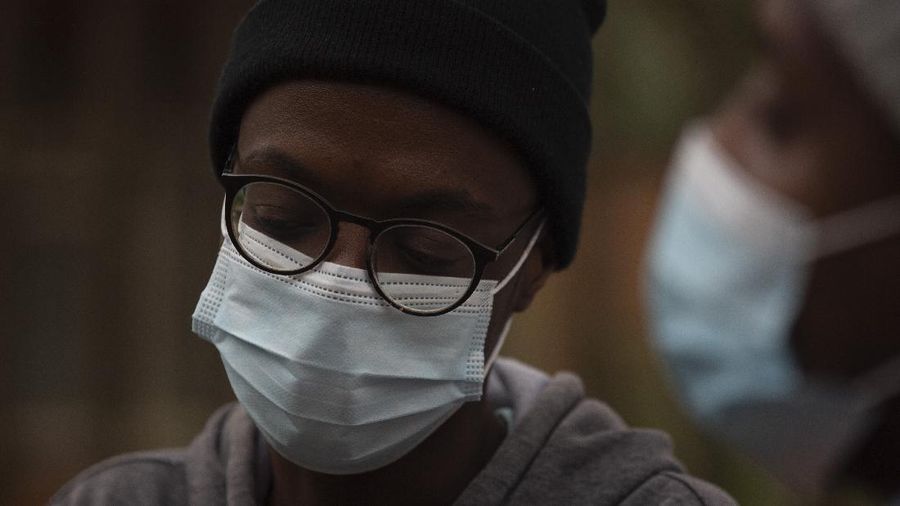 A student from the Tshwane University of Technology wears a face mask outside his residence in Pretoria, South Africa, Saturday, Nov. 27, 2021. As the world grapples with the emergence of the new variant of COVID-19, scientists in South Africa — where omicron was first identified — are scrambling to combat its spread across the country. (AP Photo/Denis Farrell)